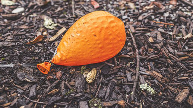 Deflated orange balloon