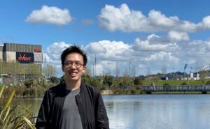 A person standing in front of a body of water

AI-generated content may be incorrect.