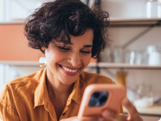 Smiling woman holding a phone